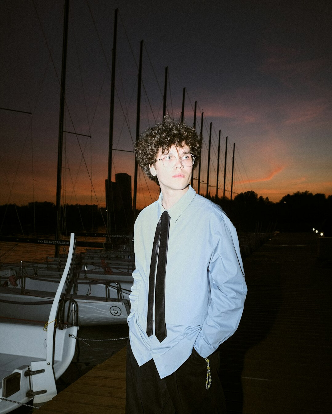 Portrait of a young man in a blue shirt and tie